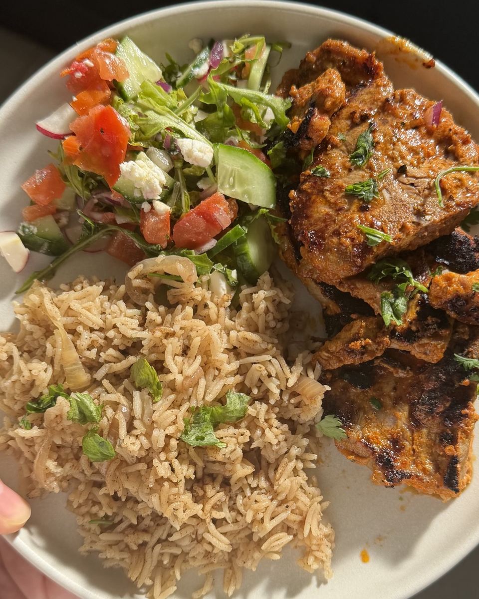 Grilled lamb with spiced rice and salad
