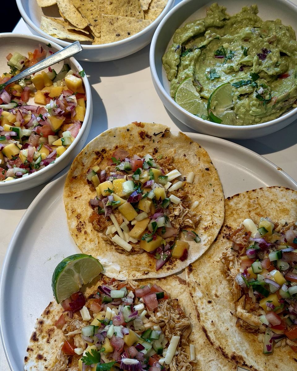 Pulled chicken tacos with mango salsa and guacamole