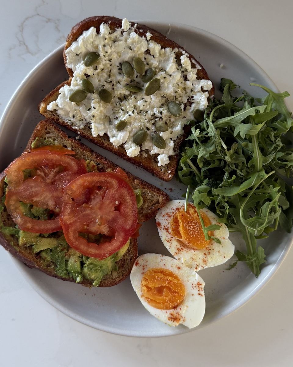 Cottage cheese and avocado toasts with egg and rocket